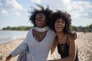 Two happy women on the beach.